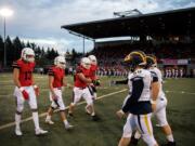 Players for Camas and Bellevue shake hands before a football game last season at Doc Harris Stadium in Camas.