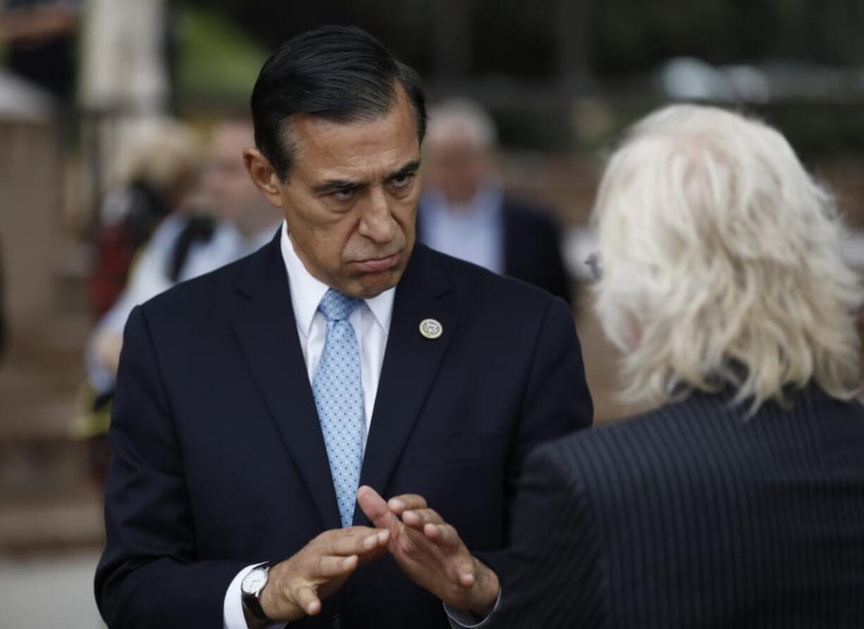 Former congressman Darrell Issa, left, speaks with a reporter after a news conference Thursday, Sept. 26, 2019, in El Cajon, Calif.  Issa, a former congressman, announced he will attempt a return to Congress to replace fellow Republican and longtime-U.S. Rep. Duncan Hunter, who is running for re-election while under indictment on corruption charges.