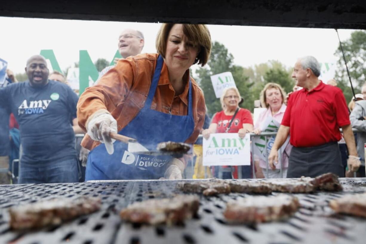 Democratic presidential candidate Sen. Amy Klobuchar works the grill during the Polk County Democrats Steak Fry, Saturday, Sept. 21, 2019, in Des Moines, Iowa.