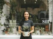 Eliza Blank from The Sill holds a Rattlesnake Calathea outside the shop in San Francisco. Blank is the founder and CEO of the popular gardening store and a plant influencer on Instagram.