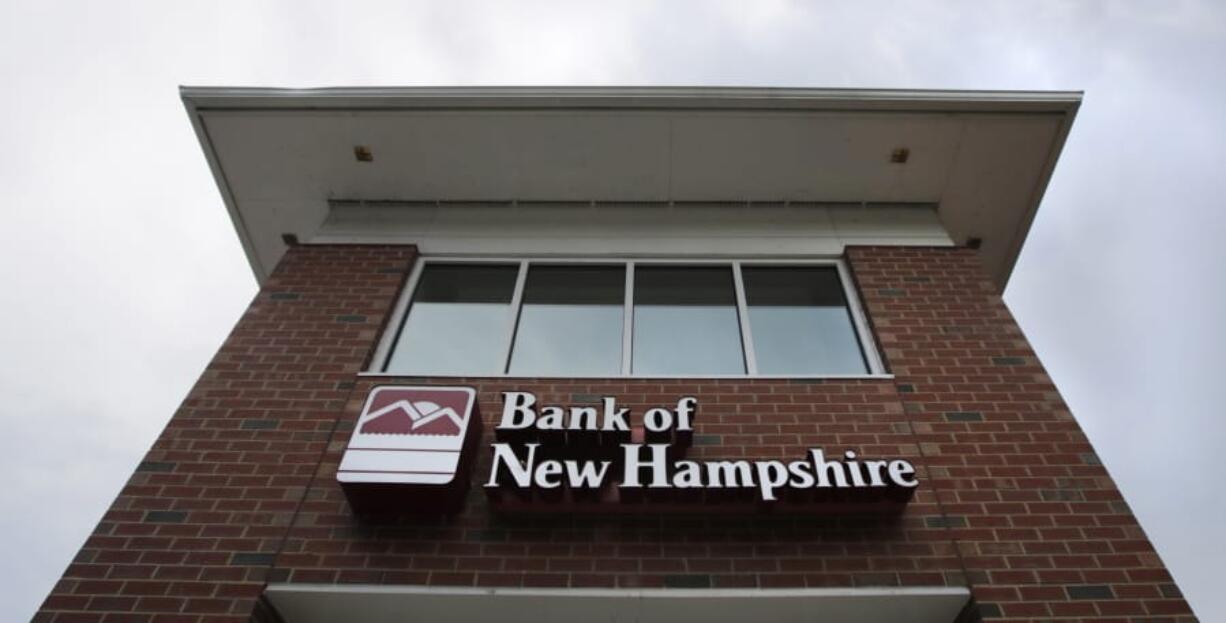 Clouds pass over the Bank of New Hampshire branch in Manchester, N.H., on Aug. 19.