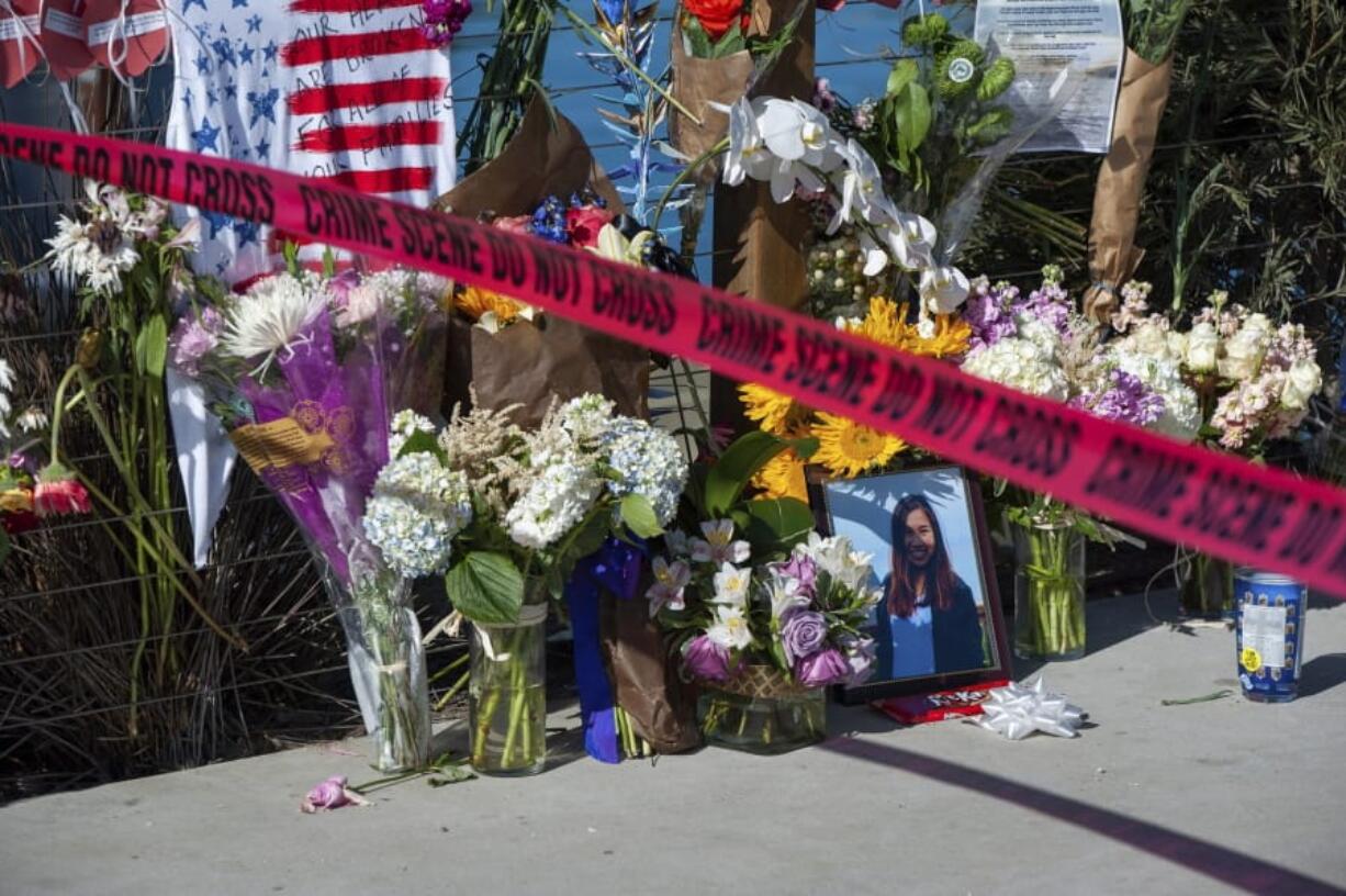 Red crime scene tape is placed by a memorial for the victims of the Conception dive boat fire on the Santa Barbara Harbor, as authorities issue a search warrant for the Truth Aquatics' offices on the Santa Barbara Harbor in Santa Barbara, Calif., Sunday, Sept. 8, 2019.