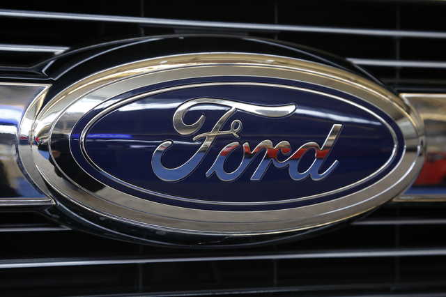 In this Feb. 11, 2016, file photo the Ford logo on the grill of is displayed at the Pittsburgh International Auto Show in Pittsburgh. Ford is recalling more than 300,000 of its 2017 Ford Explorer vehicles because of a sharp seat frame edge. The automaker said Friday, Sept. 13, 2019, that there’s been 31 reports of hand injuries. (AP Photo/Gene J.