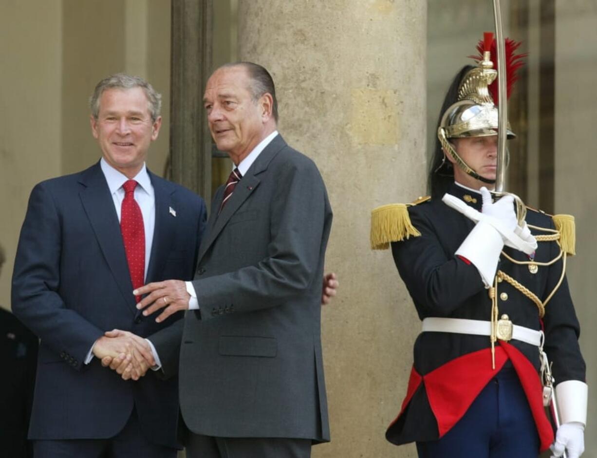 FILE - In this June 5, 2004 file photo, President Bush meets with French President Jacques Chirac as a French honor guard member stands guard at the Elysee Palace in Paris. Jacques Chirac, a debonair master of politics who championed French grandeur and whose 12 years as president were overshadowed by tensions with the United States over his opposition to war in Iraq.