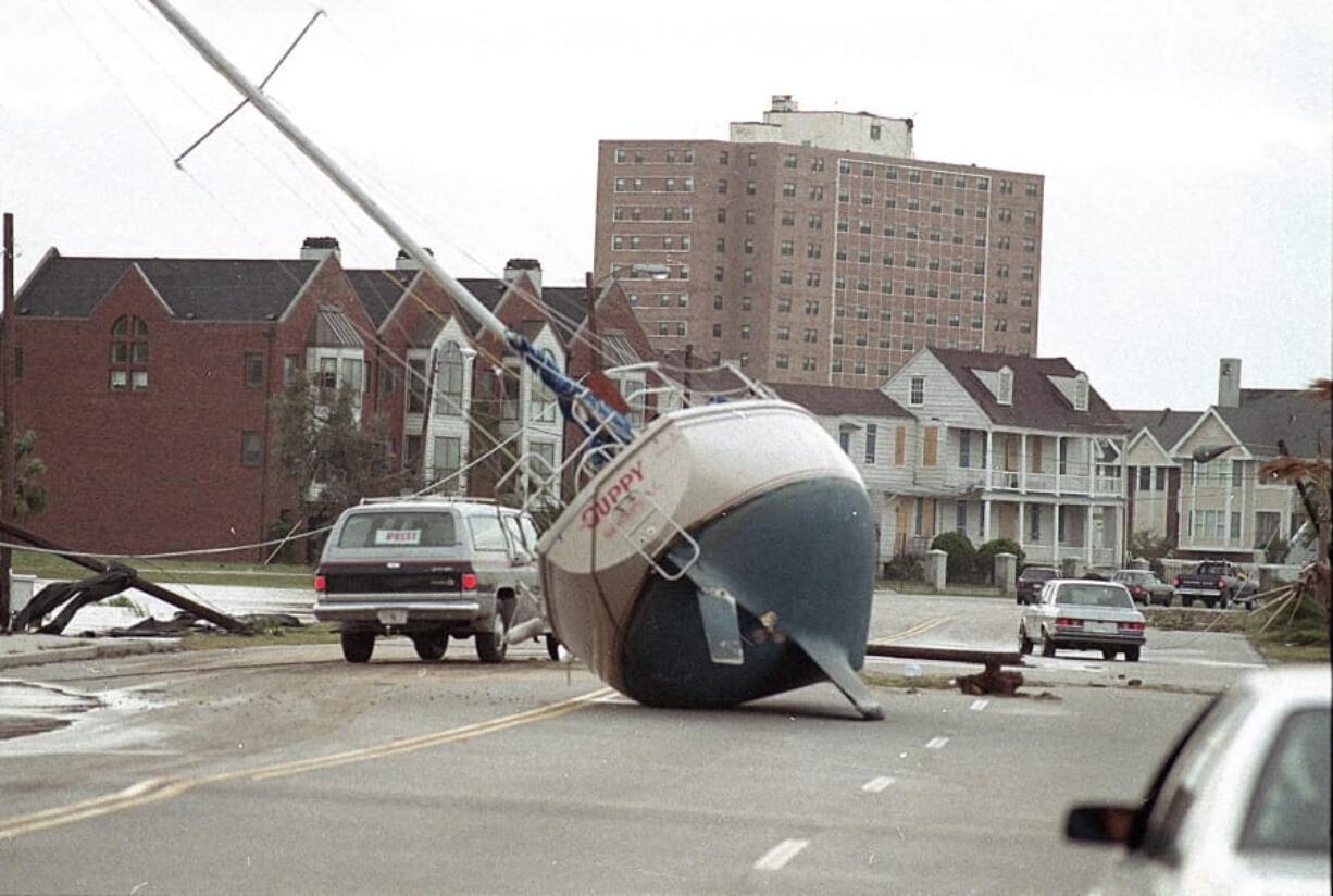 FILE- In this Sept. 22, 1989 file photo, a sailboat lies in the street of Charleston after it was washed ashore by Hurricane Hugo. From evacuating hundreds of thousands of people from the coast to live TV coverage in the shrieking wind and rain, 1989&#039;s Hurricane Hugo might have been the first U.S. storm of the modern age.