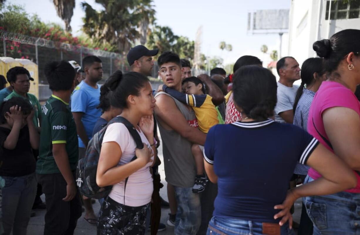 FILE - In this Aug. 1, 2019 file photo, migrants line up in Matamoros, Mexico, for a meal donated by volunteers from the U.S., at the foot of the Puerta Mexico bridge that crosses to Brownsville, Texas. A federal appeals court has put on hold a ruling that blocked a Trump administration policy that would prevent migrants from seeking asylum along the entire southwest border. The 9th U.S. Circuit Court of Appeals issued a stay Tuesday, Sept. 10, 2019 that put the ruling by U.S. District Judge Jon Tigar on hold for now. That means the administration’s asylum policy is blocked in the border states of California and Arizona but not in New Mexico and Texas. (AP Photo/Emilio Espejel.