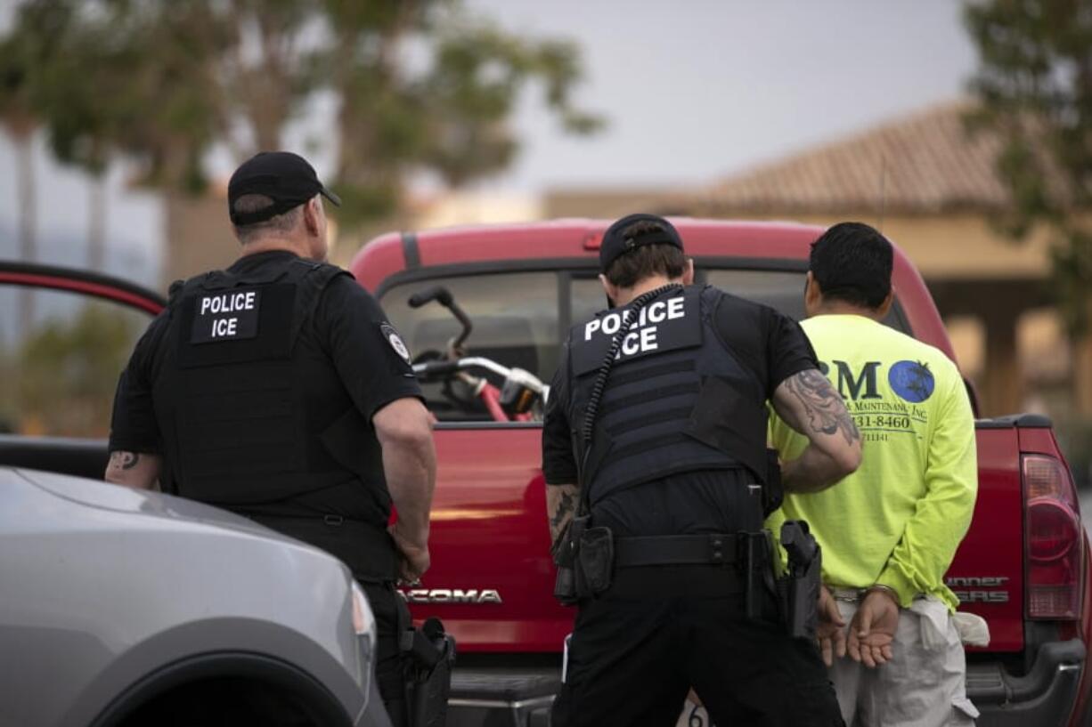 FILE - In this July 8, 2019, file photo, U.S. Immigration and Customs Enforcement (ICE) officers detain a man during an operation in Escondido, Calif. A federal judge has blocked the Trump administration&#039;s move to vastly extend authority of immigration officers to deport people without allowing them to appear before judges, the third legal setback for its immigration agenda in one day.