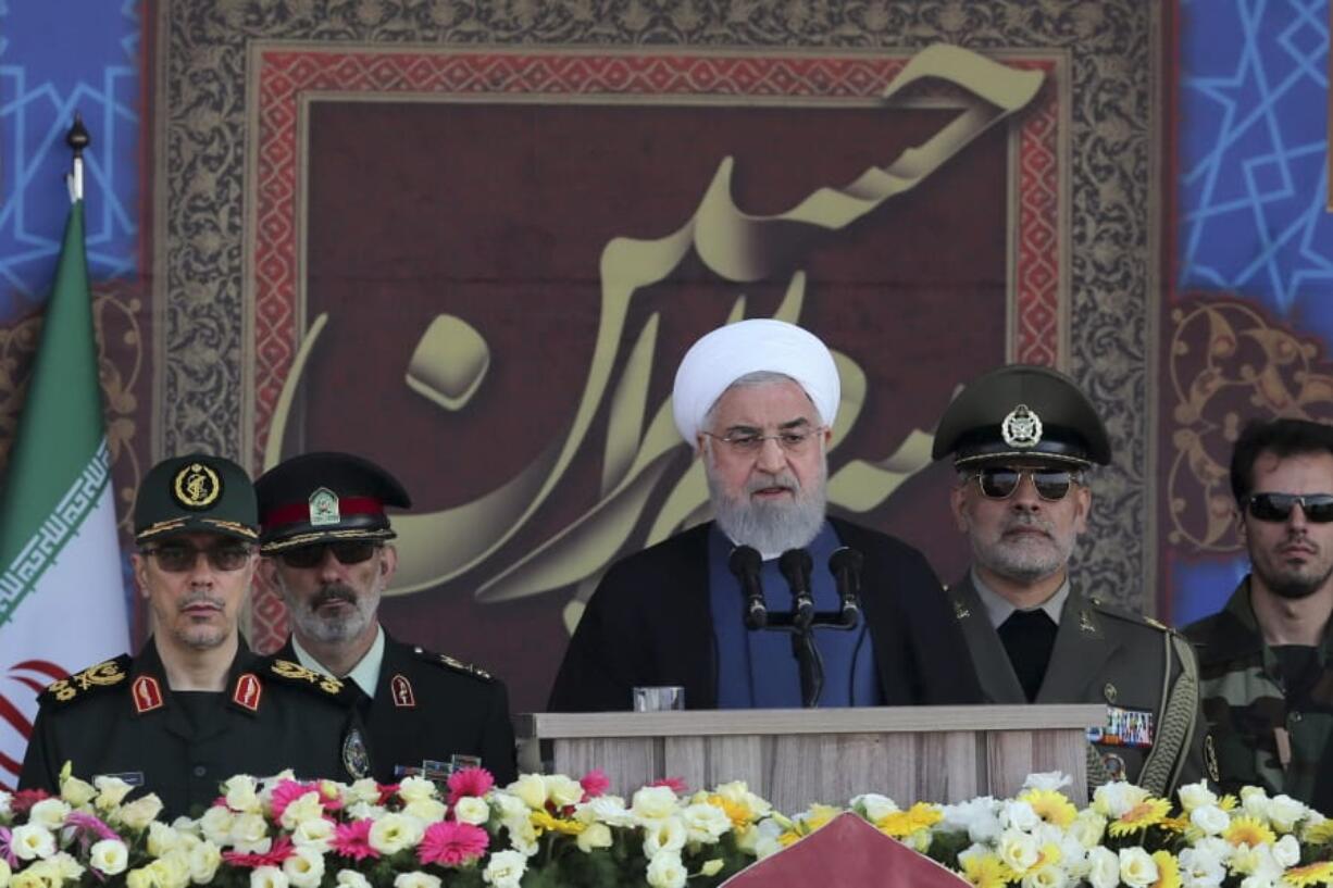 In this photo released by the official website of the office of the Iranian Presidency, President Hassan Rouhani speaks at a military parade marking 39th anniversary of outset of Iran-Iraq war, in front of the shrine of the late revolutionary founder Ayatollah Khomeini, just outside Tehran, Iran, Sunday, Sept. 22, 2019. Chief of the General Staff of the Armed Forces Gen. Mohammad Hossein Bagheri stands at left.