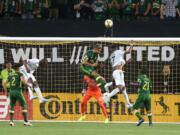 New England Revolution's Juan Agudelo (17) tries to head the ball toward the goal during the team's MLS soccer match against the Portland Timbers on Wednesday, Sept. 25, 2019, in Portland, Ore.