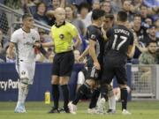 Sporting Kansas City midfielder Roger Espinoza (17) grabs Portland Timbers midfielder Sebastian Blanco (10), second from right during a scuffle in the first half of an MLS soccer game Sunday, Sept. 29, 2019, in Kansas City, Kan.