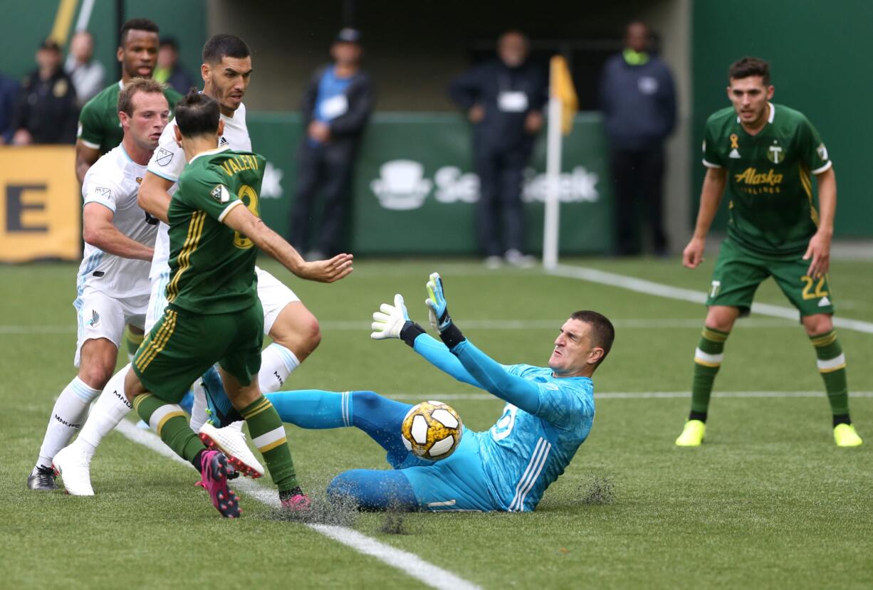 Minnesota United FC goalkeeper Vito Mannone (1) makes a save against Portland Timbers'  Diego Valeri (7) during an MLS soccer match at Providence Park, Sunday, Sept. 22, 2019, in Portland, Ore.