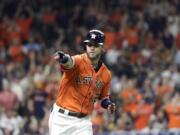 Houston Astros’ Josh Reddick points to the dugout after hitting a home run against the Seattle Mariners during the fourth inning of a baseball game Friday, Sept. 6, 2019, in Houston. (AP Photo/David J.