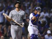 Seattle Mariners’ Ryan Court left, reacts after striking out, next to Chicago Cubs catcher Willson Contreras during the first inning of a baseball game Tuesday, Sept. 3, 2019, in Chicago.