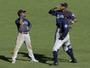 Seattle Mariners outfielders Shed Long (39), Keon Broxton, right rear, and Kyle Lewis, front right, celebrate a win over the Pittsburgh Pirates on Thursdaty in Pittsburgh. (Gene J.