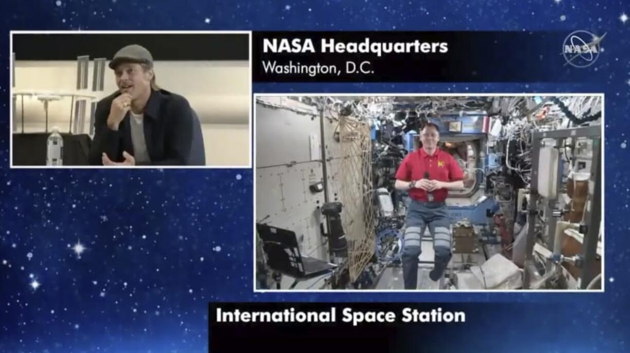 In this image taken from NASA video actor Brad Pitt, left, star of the new space movie &quot;Ad Astra,&quot; speaks from NASA headquarters in Washington, to astronaut Nick Hague abroad the International Space Station, on Monday, Sept. 16, 2019.