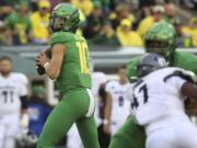 Oregon’s Justin Herbert looks for a receiver during the third quarter of the team’s NCAA college football game against Nevada on Saturday, Sept. 7, 2019, in Eugene, Ore.