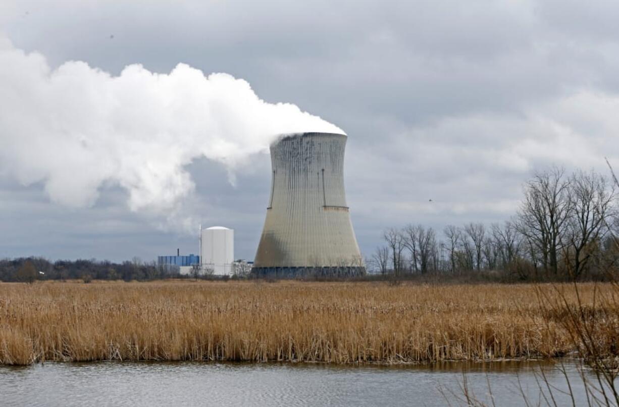 Plumes of steam drift from the cooling tower of FirstEnergy Corp.’s Davis-Besse Nuclear Power Station in April 2017 in Oak Harbor, Ohio.