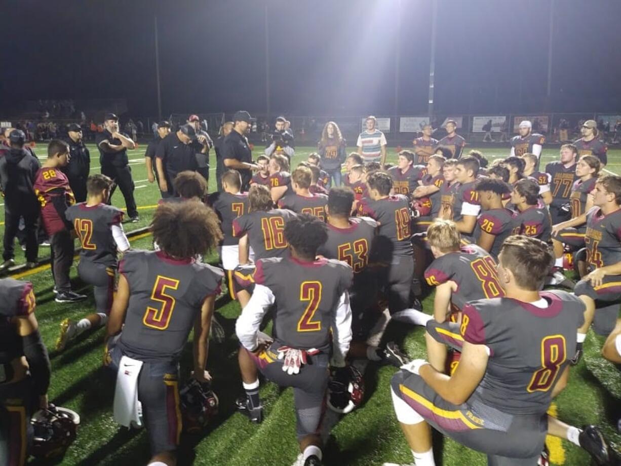 Prairie coach Mike Peck talks to his players after the Falcons' 36-6 win over Washougal (Tim Martinez/The Columbian)