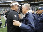 New Orleans Saints head coach Sean Payton, left, talks with Seattle Seahawks head coach Pete Carroll, right, after an NFL football game, Sunday, Sept. 22, 2019, in Seattle. (AP Photo/Ted S.