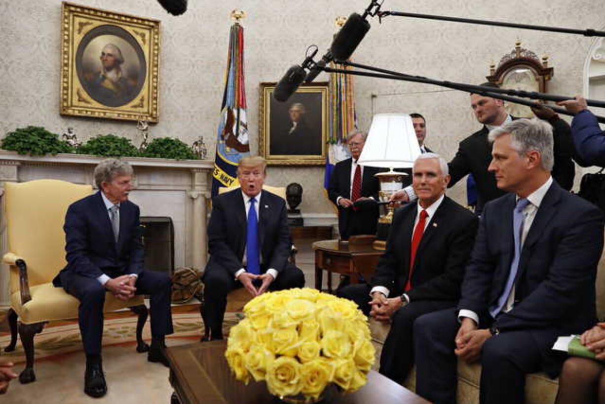 In this March 6, 2019, file photo, former U.S. hostage in Yemen, Danny Burch, left, listens as President Donald Trump speaks, Wednesday, March 6, 2019, in the Oval Office of the White House in Washington, next to Vice President Mike Pence, and Special Presidential Envoy for Hostage Affairs Robert O'Brien. At back, to the right of Trump, is then-national security adviser John Bolton. President Donald Trump says he plans to name O'Brien to be his new national security adviser.