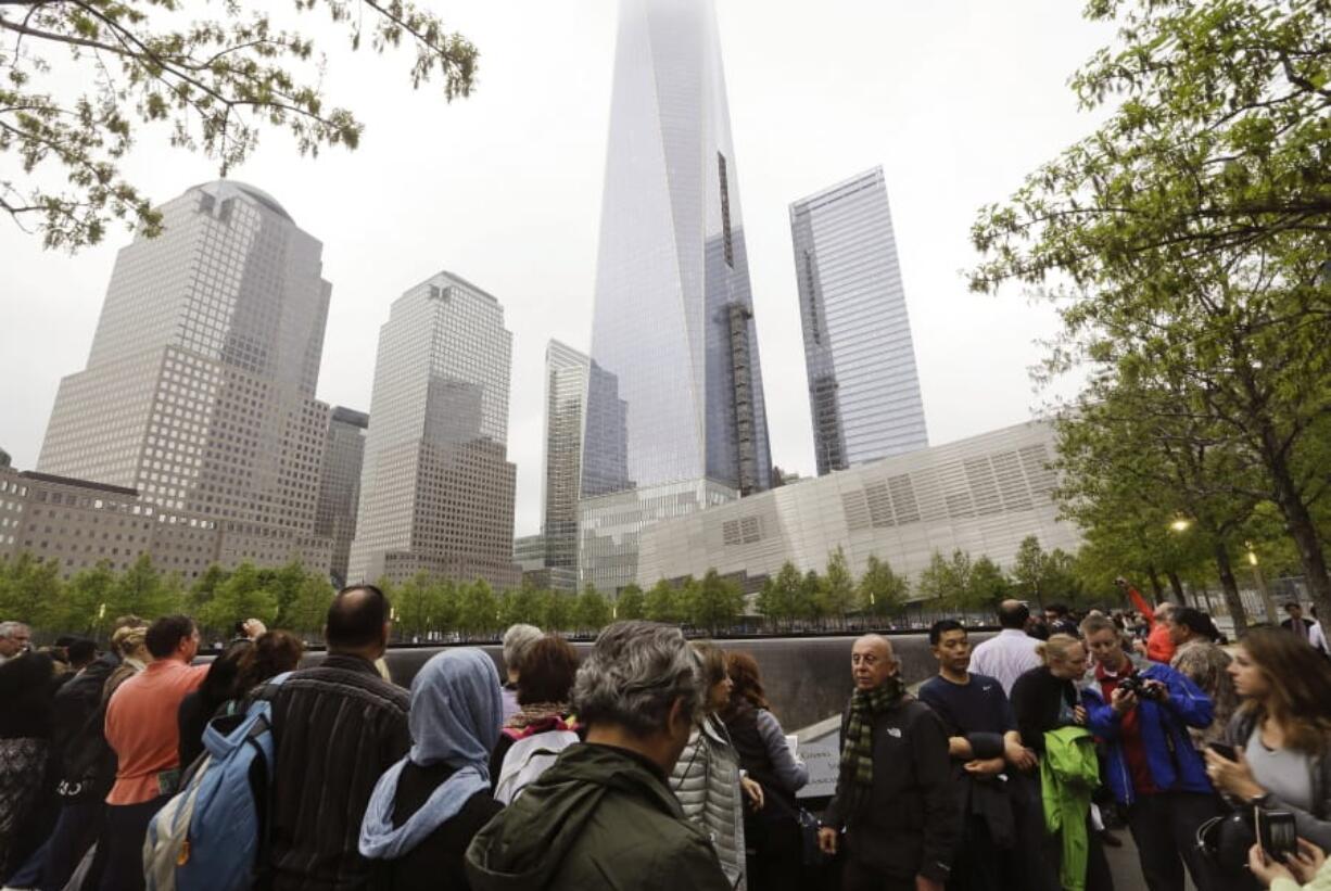 FILE- In this May 15, 2015 file photo, visitors gather near the pools at the 9/11 Memorial in New York. As they have done 17 times before, a crowd of victims’ relatives is expected at the site on Wednesday, Sept. 11, 2019 to observe the anniversary the deadliest terror attack on American soil.