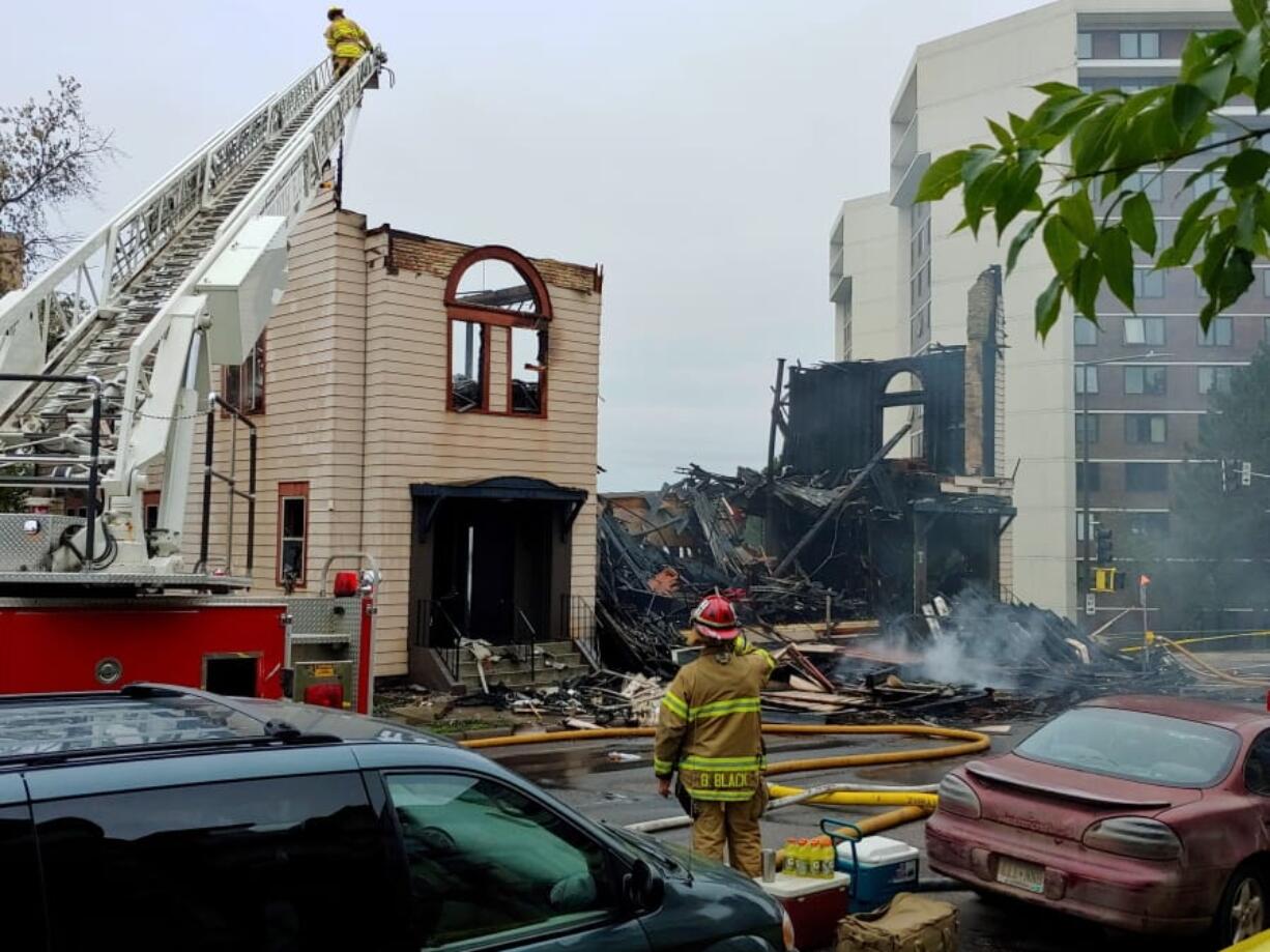 Firefighters work the scene of an overnight fire that engulfed and destroyed a synagogue in downtown Duluth, Minn., Monday, Sept. 9, 2019.