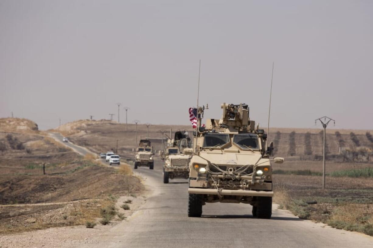 U.S. armored vehicles travel in a joint patrol of the safe zone between Syria and the Turkish border Friday with the Tal Abyad Military Council near Tal Abyad, Syria.