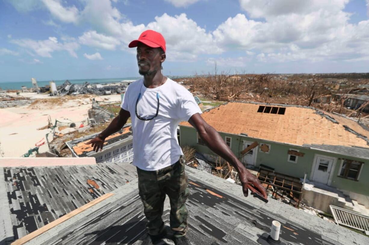 Jackson Blatch starts repairs on the roof of his home in Marsh Harbor, Abaco Island, Bahamas, Saturday, Sept. 7, 2019 after Hurricane Dorian hit.