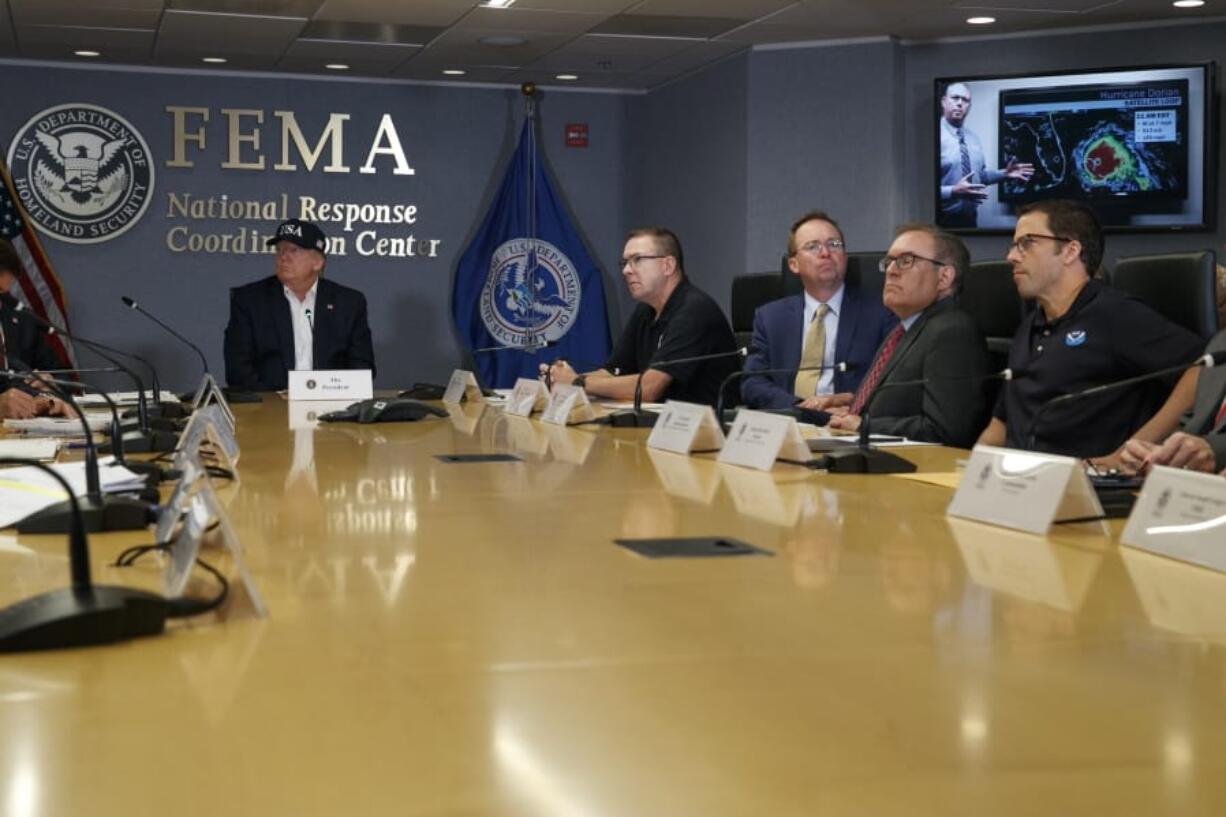 President Donald Trump, left, listens as Kenneth Graham, director of NOAA’s National Hurricane Center, on screen, gives an update during a briefing about Hurricane Dorian at the Federal Emergency Management Agency (FEMA), Sunday, Sept. 1, 2019, in Washington, at right of Trump is Acting Administrator Pete Gaynor, Federal Emergency Management Agency, and acting White House chief of staff, Mick Mulvaney, Environmental Protection Agency (EPA) Administrator Andrew Wheeler, and Neil Jacobs, Assistant Secretary of Commerce for Environmental Observation and Prediction.