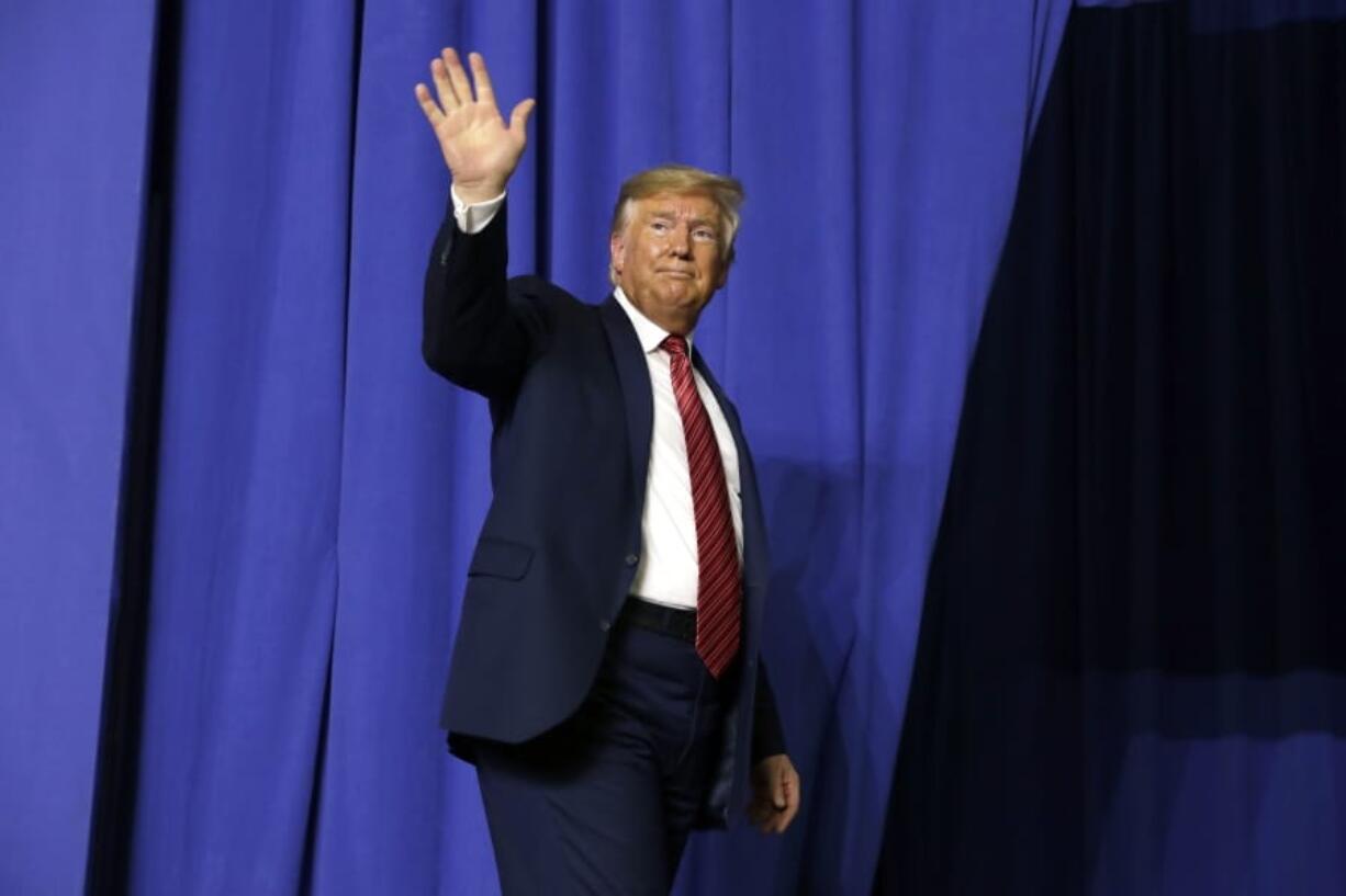 President Donald Trump waves after speaking with Australian Prime Minister Scott Morrison at Pratt Industries, Sunday, Sept 22, 2019, in Wapakoneta, Ohio.