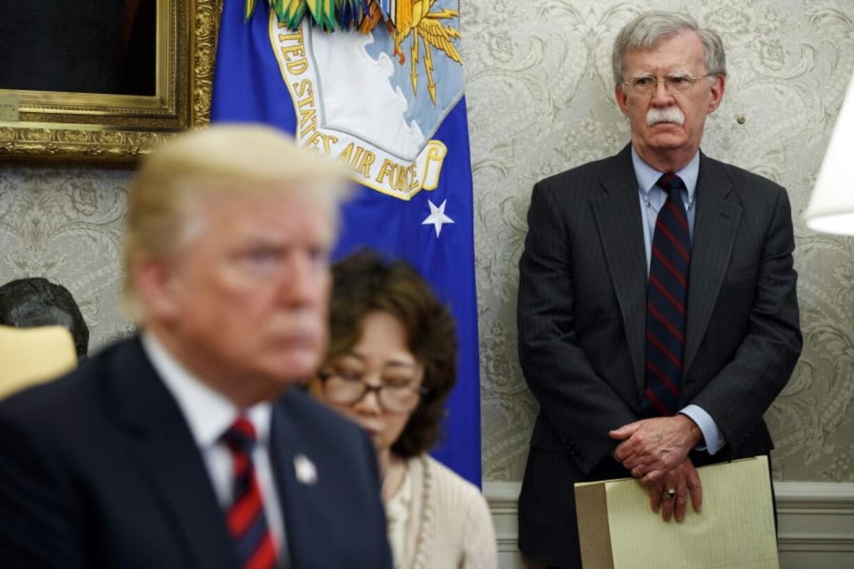 In this May 22, 2018, file photo, U.S. President Donald Trump, left, meets with South Korean President Moon Jae-In in the Oval Office of the White House in Washington, as national security adviser John Bolton, right, watches. Trump says he fired national security adviser John Bolton, says they ‘disagreed strongly’ on many issues.