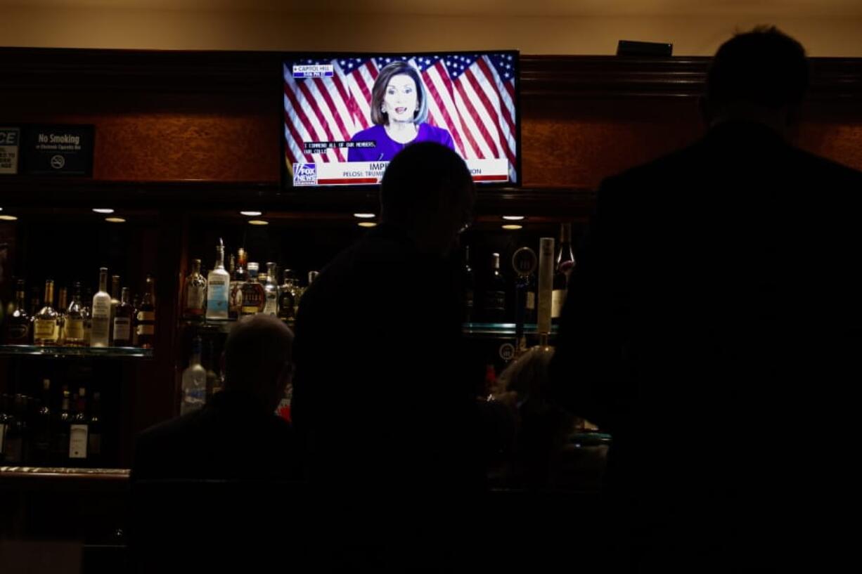 Journalists watch Speaker of the House Nancy Pelosi of Calif. announce a formal impeachment inquiry of President Donald Trump, in the Trump Tower bar, Tuesday, Sept. 24, 2019, in New York.