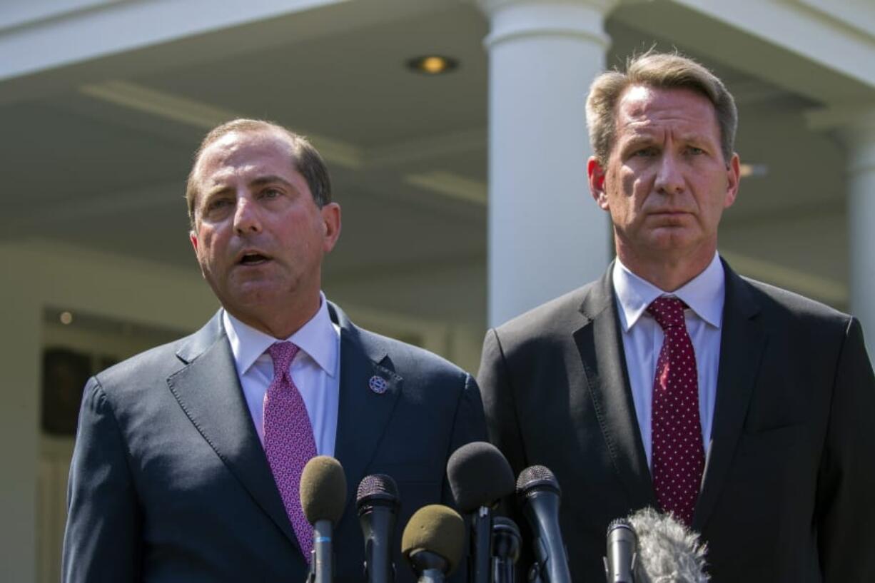 Health and Human Services Secretary Alex Azar, left, and acting FDA Commissioner Ned Sharpless speak with reporters after a meeting about vaping with President Donald Trump in the Oval Office of the White House, Wednesday, Sept. 11, 2019, in Washington.