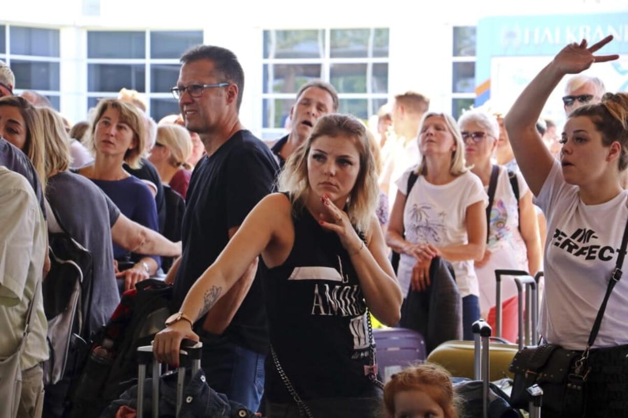 British passengers with Thomas Cook wait in queue at Antalya airport in Antalya, Turkey, Monday Sept. 23, 2019. Hundreds of thousands of travellers were stranded across the world Monday after British tour company Thomas Cook collapsed, immediately halting almost all its flights and hotel services and laying off all its employees.