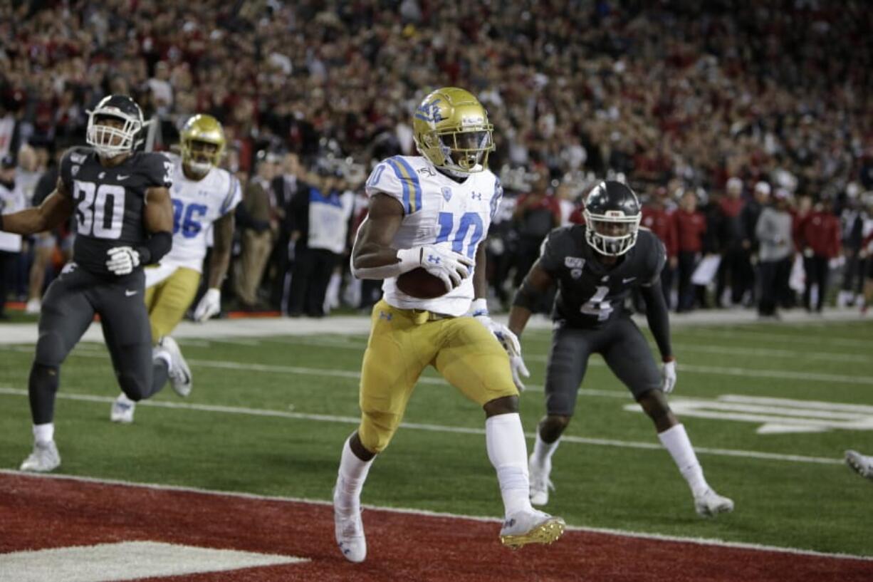 UCLA wide receiver Demetric Felton (10) scores the go ahead touchdown during the second half of an NCAA college football game against Washington State in Pullman, Wash., Saturday, Sept. 21, 2019. UCLA won 67-63.