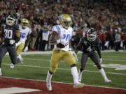 UCLA wide receiver Demetric Felton (10) scores the go ahead touchdown during the second half of an NCAA college football game against Washington State in Pullman, Wash., Saturday, Sept. 21, 2019. UCLA won 67-63.