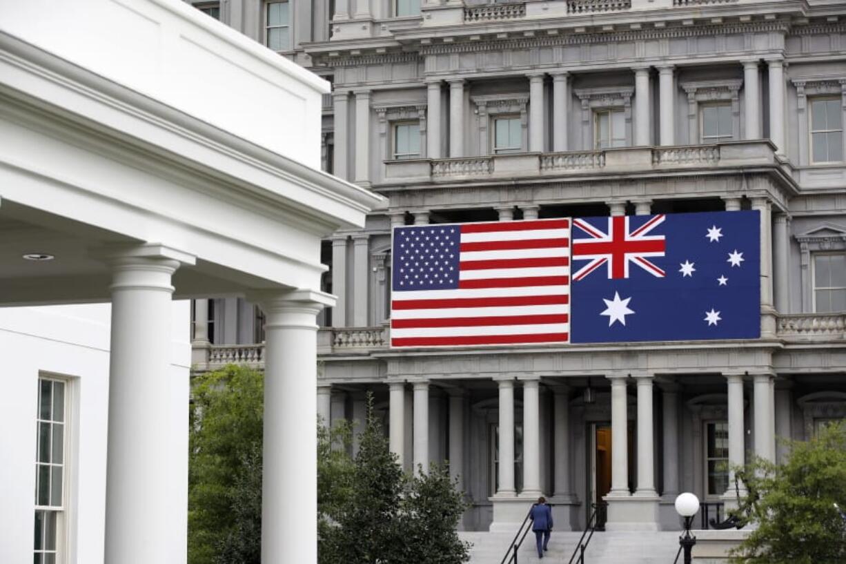 An American and Australian flag hang from the Eisenhower Executive Office Building on the grounds of the White House Complex in Washington, Tuesday, Sept. 17, 2019, ahead of Australian Prime Minister Scott Morrison&#039;s state visit. President Donald Trump is scheduled to welcome Morrison to the White House Friday, Sept. 20.