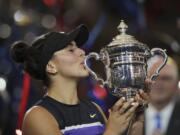 Bianca Andreescu, of Canada, kisses the championship trophy after defeating Serena Williams, of the United States, in the women’s singles final of the U.S. Open tennis championships Saturday, Sept. 7, 2019, in New York.