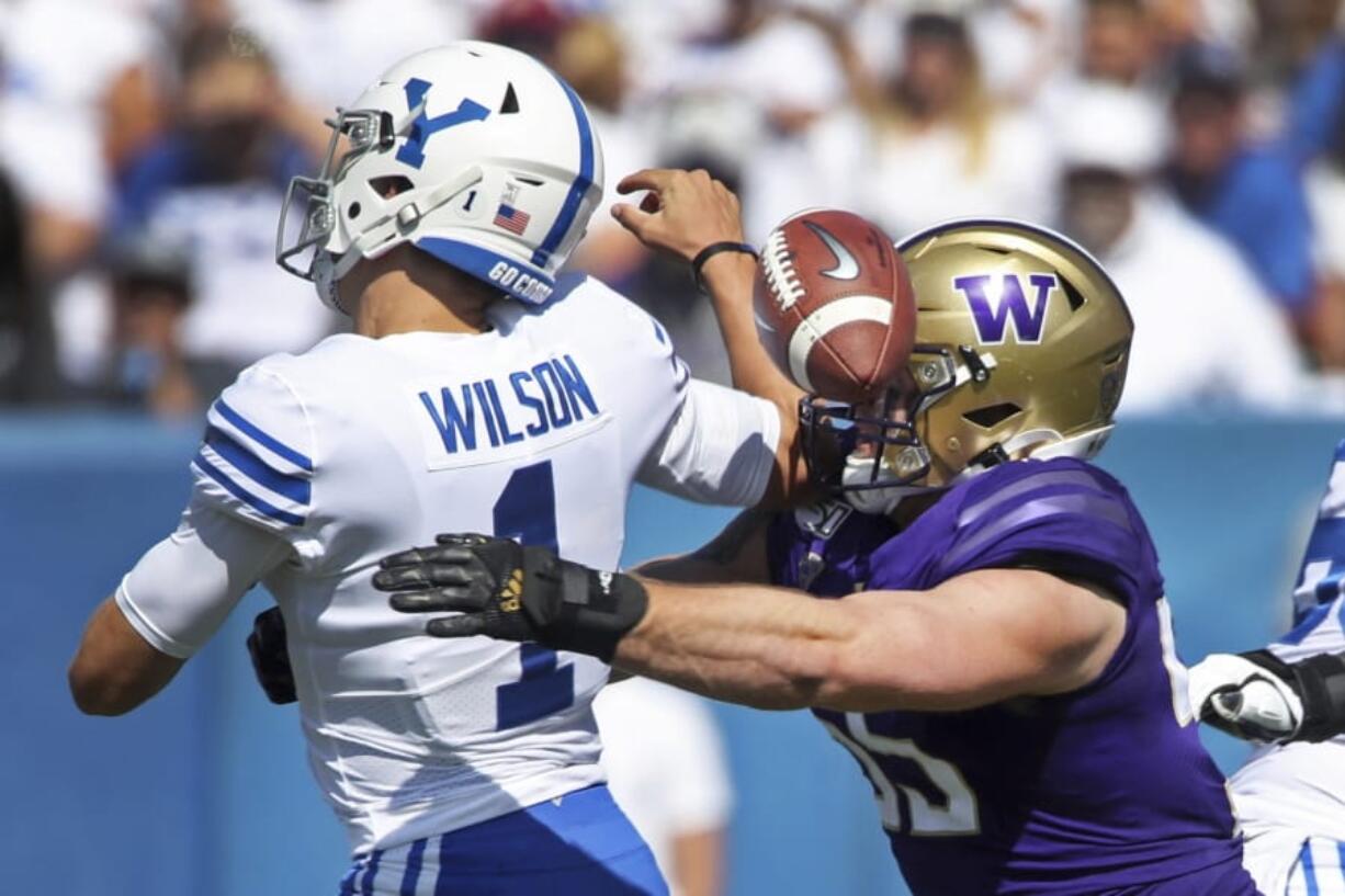 BYU quarterback Zach Wilson (1) fumbles the ball as he is hit by Washington linebacker Ryan Bowman (55) in the first half during an NCAA college football game, Saturday, Sept. 21, 2019, in Provo, Utah.