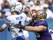 BYU quarterback Zach Wilson (1) fumbles the ball as he is hit by Washington linebacker Ryan Bowman (55) in the first half during an NCAA college football game, Saturday, Sept. 21, 2019, in Provo, Utah.