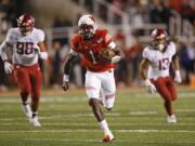 Utah quarterback Tyler Huntley (1) carries the ball against Washington State in the first half of an NCAA college football game Saturday, Sept. 28, 2019, in Salt Lake City.