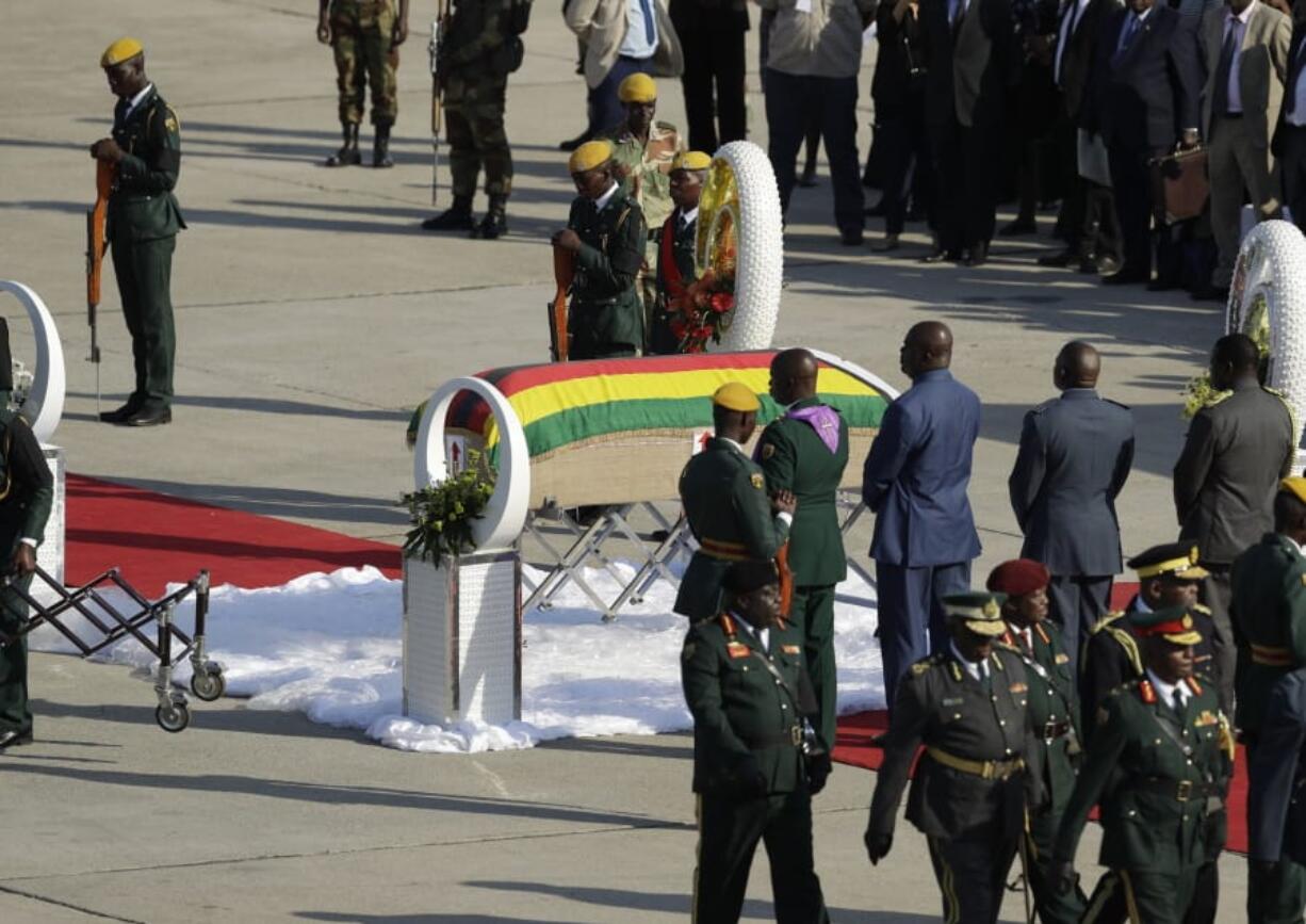 A coffin carrying the remains of Zimbabwe’s longtime ruler Robert Mugabe arrives from Singapore, at the RG Mugabe International Airport in Harare, Wednesday Sept. 11, 2019. The body of Mugabe is being flown to the capital, Harare, on Wednesday where it will be displayed at historic locations for several days before burial at a location still undecided because of friction between the ex-leader’s family and the government.