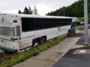 No one was injured when a tour bus driven by Kenneth Alexander, 44, of Vancouver crashed into a sidewalk in Manzanita, Ore. The bus was carrying 46 Army National Guard members. Alexander is suspected of having been under the influence.