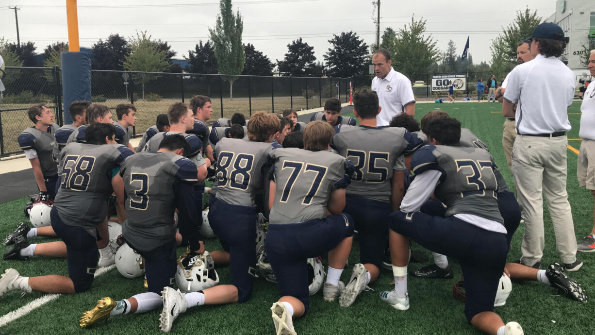 Seton Catholic head coach Dan Chase addresses the Cougars after their season-opening 19-8 victory Saturday over Chimacum.