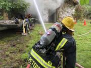 Camas-Washougal fire firefighters battle an outbuilding fire on G Street in 2019.