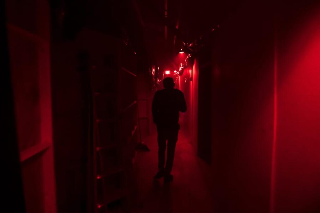 Jason Greeley-Roberts, an owner of the Clark County Scaregrounds, walks through an access corridor behind one of his haunts while checking on the actors in 2018. Scaregrounds takes place at Clark County Fairgrounds through Halloween.