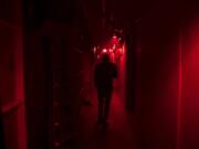 Jason Greeley-Roberts, an owner of the Clark County Scaregrounds, walks through an access corridor behind one of his haunts while checking on the actors in 2018. Scaregrounds takes place at Clark County Fairgrounds through Halloween.