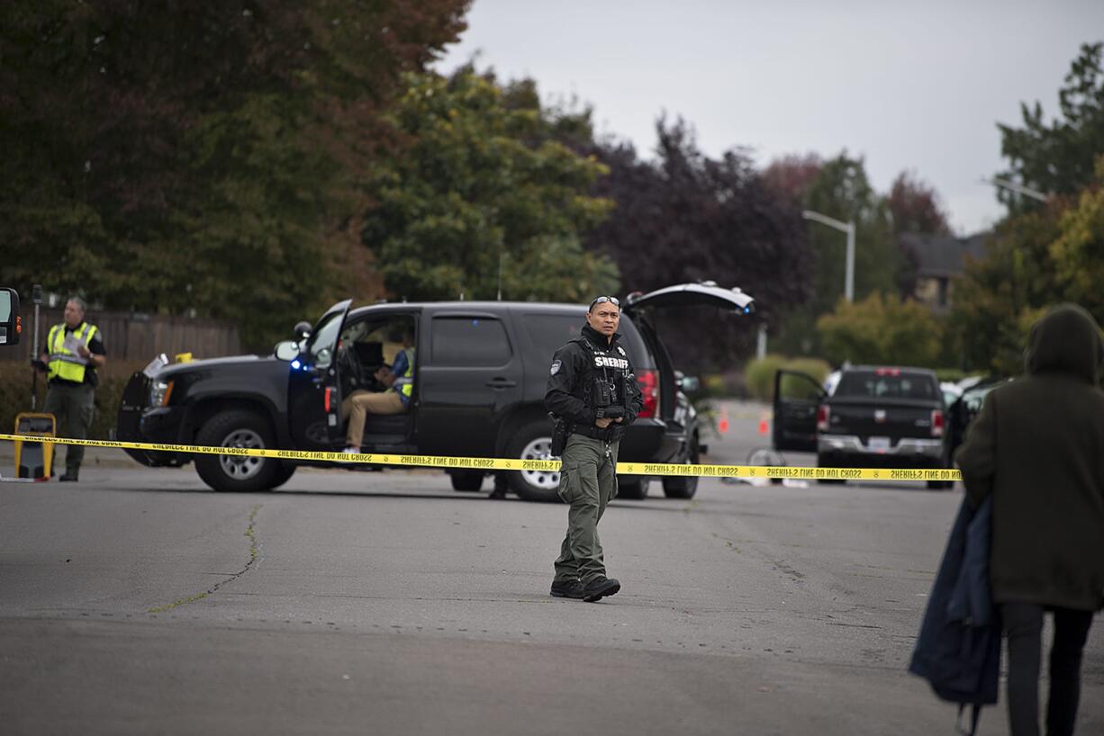 Officials work at the scene of a fatal crash in east Vancouver involving a pickup truck and a child on a bicycle Tuesday morning. The Clark County Medical Examiner's Office identified the boy as Damien T. Vandecasteele, 10.