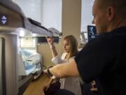 Mammography Technologist Aimee Lehartel, center, and Dr. Michael Morich explain how their new breast cancer biopsy machine works at PeaceHealth Southwest Medical Center in Vancouver. PeaceHealth purchased the machine in March, and Lehartel calls it &quot;the newest, latest and greatest&quot; technology available.