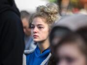 Tiffany Chandler watches her mother, Sharrin Chandler McDade, walk across the stage of the Oct. 5 Portland Out of the Darkness Walk after sharing the story of Tiffany&#039;s sister, Courtney, and father, Justun, who chose to end their lives on the same day about three years ago.